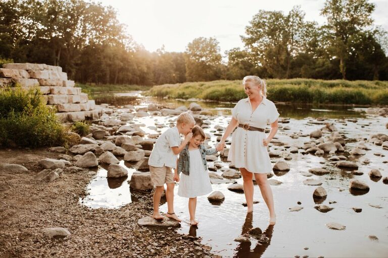 Oak Brook IL extended family playing by the creek during golden hour