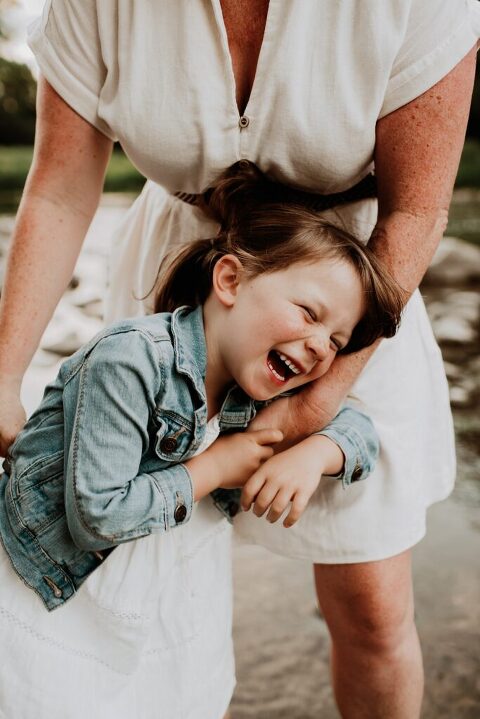 Child laughing while inside the creek in Oak Brook, Illinois