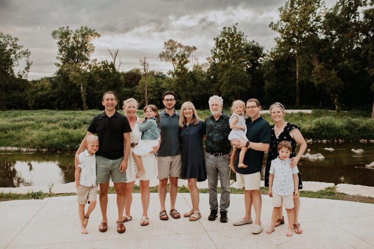 Multi-generation family smiling together outdoors in Oak Brook