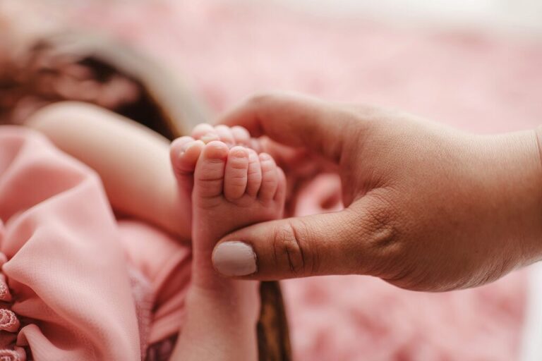 Close-up of newborn baby girl’s toes
